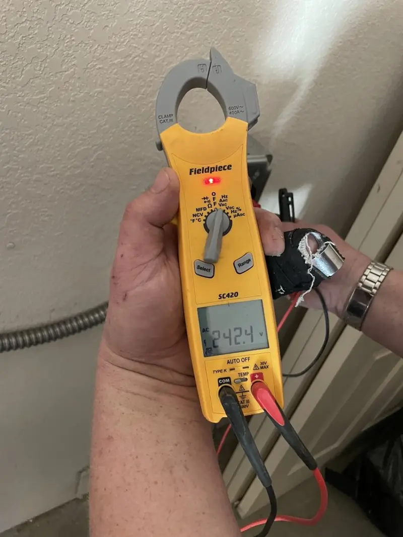 Voltage testing with clamp meter during Electrical Installation Services in Kirtland AFB